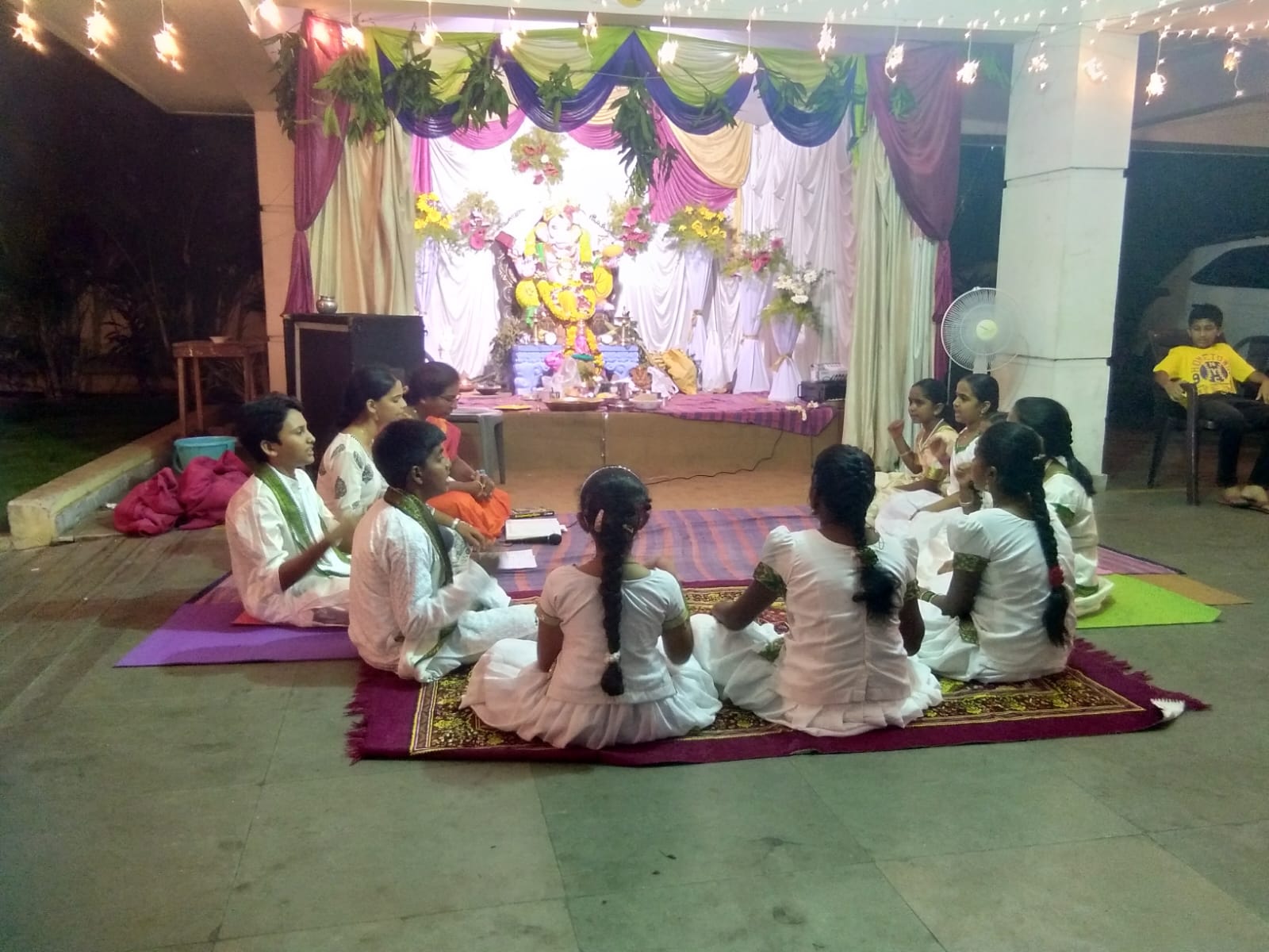 Students performing Keerthanas at a stage event